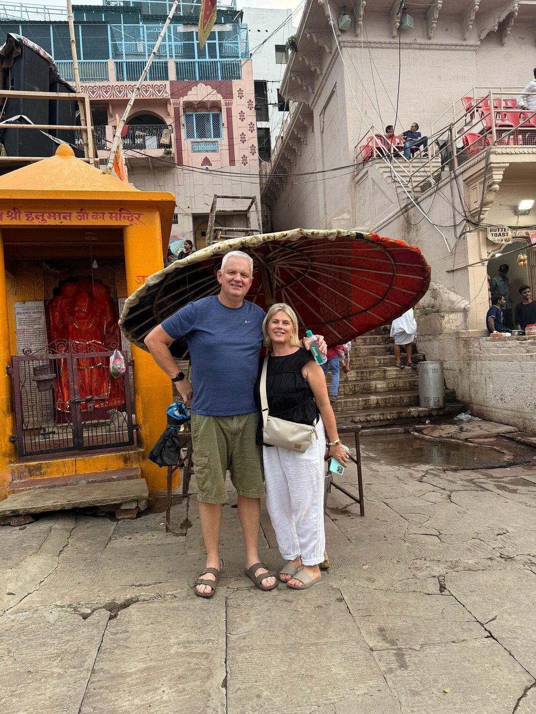 Historic stone riverfront and morning boat life along Varanasi Ghats